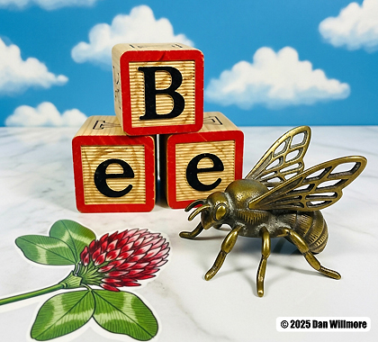 Picture of a bee with ABC blocks that spell the word "BEE."